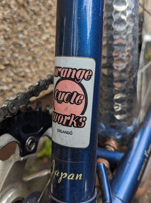 A sticker reading "orange cycle works"